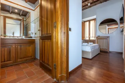 a bathroom with a sink and a bed in a room at Trevi Room in Rome
