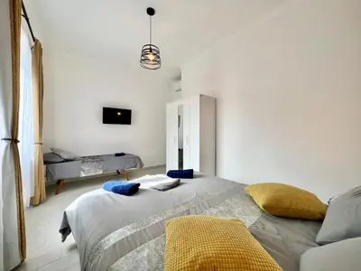 a bedroom with a bed and a couch at Stylish Apartment near Trastevere in Rome