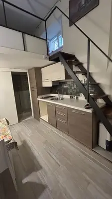 a large kitchen with a staircase in a loft at Parioli Independent Room in Rome