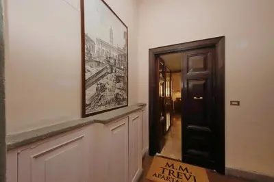 a hallway with a picture on the wall next to a door at MM Trevi Apartment in Rome