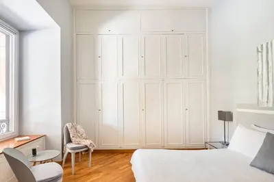 a white bedroom with a large white closet at Nido degli Artisti in Trastevere Piazza Trilussa in Rome