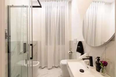 a bathroom with a shower and a sink and a mirror at Piazza del Popolo Boutique GuestHouse in Rome