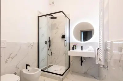 a bathroom with a shower and a toilet and a sink at Piazza del Popolo Boutique GuestHouse in Rome