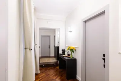 a hallway with a vase of flowers on a table at Piazza del Popolo Boutique GuestHouse in Rome