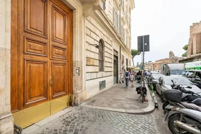 a building with a wooden door on the side of a street at Sweet Home Colosseum in Rome