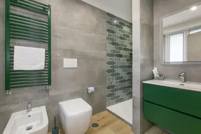 a bathroom with a white toilet and a sink at Roma Vaticano Deluxe in Rome