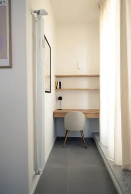 a desk and a chair in a room with a window at Beautiful Penthouse Roma in Rome