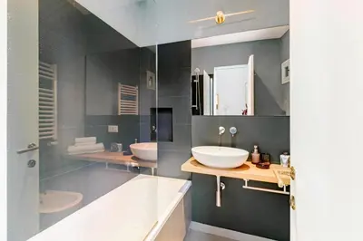 a bathroom with two sinks and a tub and a mirror at Unique Piazza Navona 2 Bedrooms and Home Cinema in Rome