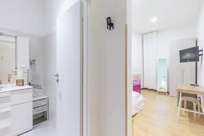 a white kitchen with a sink and a table at Alloggi Costantini - Ospedale Gemelli - Metro Battistini in Rome