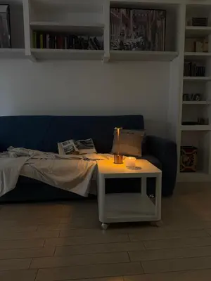 a room with a bed and a table with a lamp at Silvestri206 in Rome