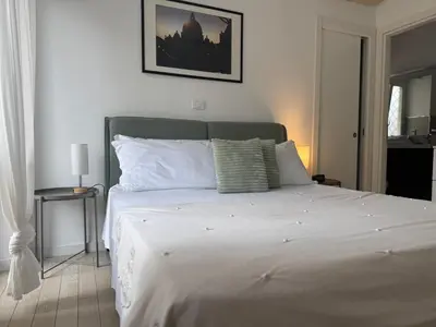 a bedroom with a large bed with white sheets at Silvestri206 in Rome