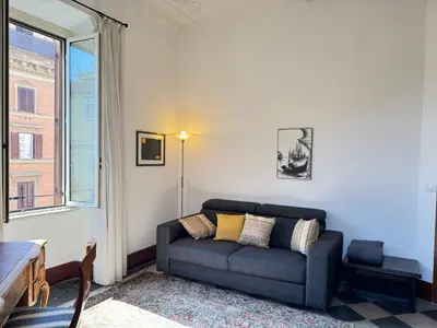a living room with a couch and a window at Casa Angeli 2 in Rome