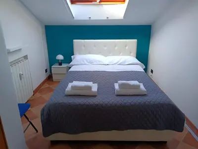 a bedroom with a large bed with two pillows on it at Attico GianLuce in Rome