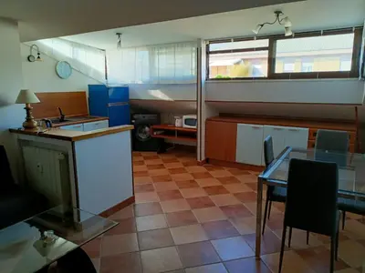 a kitchen with a sink and a table in a room at Attico GianLuce in Rome