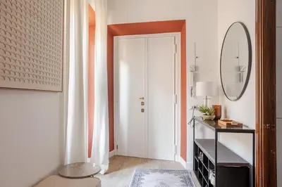 a hallway with a white door and a mirror at Piazza di Spagna 2 Bedrooms and 5 Juliet Balcony in Rome