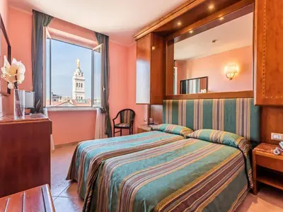 a hotel room with a bed and a window at Raeli Hotel Siracusa in Rome