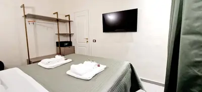 two white towels sitting on a bed in a room at Roma Suite Style in Rome