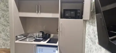 a small kitchen with a sink and a microwave at Roma Suite Style in Rome