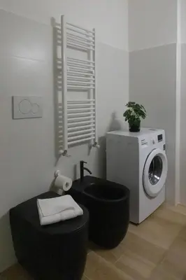 a bathroom with a sink and a washing machine at Cecilia s House in Rome