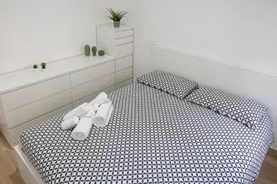 a bedroom with a bed with white shoes on it at Cecilia s House in Rome