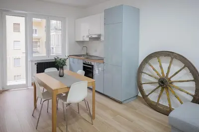 a kitchen and dining room with a table and a wheel at Cecilia s House in Rome