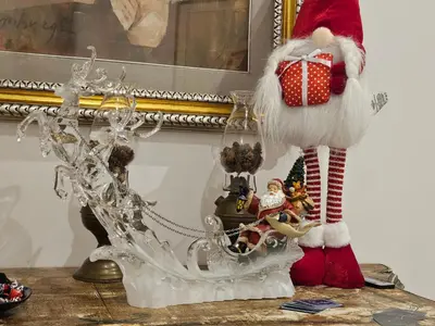a santa claus figurine with a gift on a table at B&B CasaBentivoglio in Rome