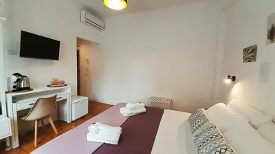 a bedroom with a bed and a desk and a television at B&B CasaBentivoglio in Rome