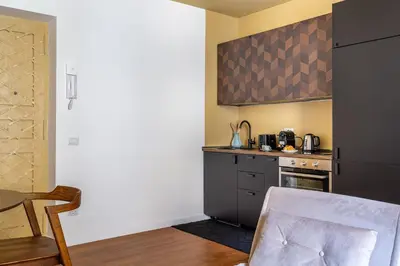a kitchen with a table and a counter top at iFlat Warm & Welcoming Little Gem in Rione Monti in Rome