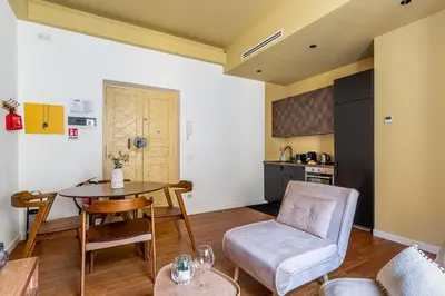 a living room with a table and a chair at iFlat Warm & Welcoming Little Gem in Rione Monti in Rome
