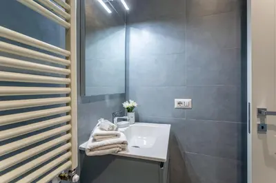 a bathroom with a sink and a mirror at iFlat Stylish New Flat Steps from the Vatican in Rome