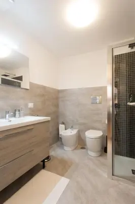 a bathroom with a sink and a toilet and a shower at Domenichino Luxury Home in Rome