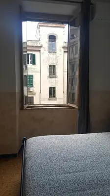 a bedroom with a window looking out at a building at Roma centro little house of testaccio in Rome