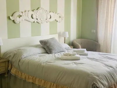 a bedroom with a bed with two towels on it at Mami Guest House Rome Vatican St Peters in Rome