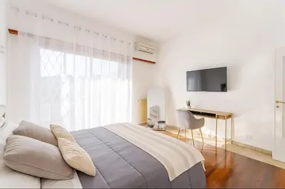 a white bedroom with a large bed and a desk at 85mq of Vintage Luxury-Near Vatican City WIFI AC in Rome