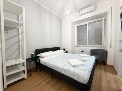 a white bedroom with a bed and a window at Riboty Boutique Rooms in Rome
