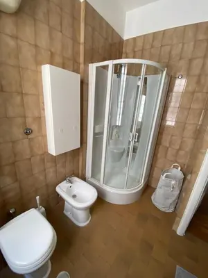a bathroom with a toilet and a shower and a sink at The 7th in Rome