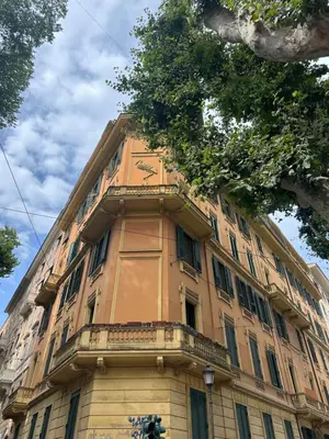 an orange building with a clock on it at Romart Luxury Rooms in Rome