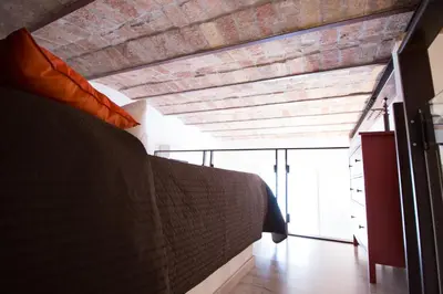 a room with a brick wall and a bed at Inner House in Rome