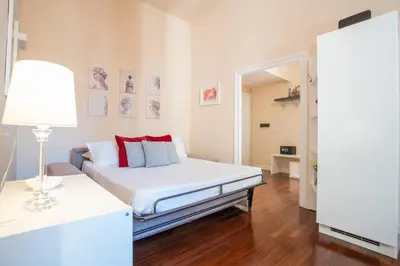 a bedroom with a bed and a table with a lamp at Pgrhome Campitelli in Rome