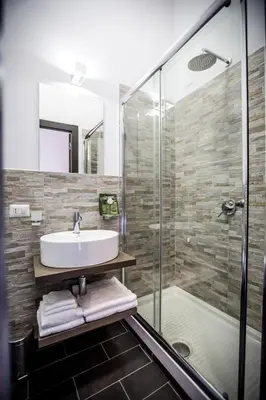 a bathroom with a sink and a shower at San Pietro Leisure and Luxury in Rome