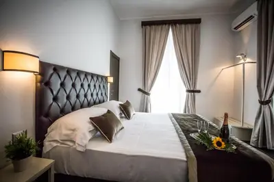 a bedroom with a large bed and a window at San Pietro Leisure and Luxury in Rome