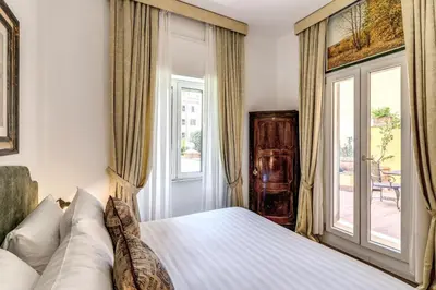 a bedroom with a bed and a window at BoHo Studio & Terrace in Rome