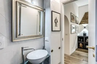 a bathroom with a sink and a mirror at BoHo Studio & Terrace in Rome