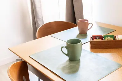 a wooden table with two cups on top of it at Comfort Suite Balduina - Rome in Rome