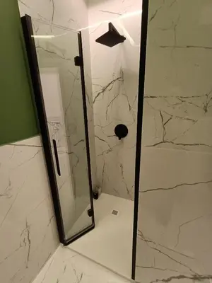 a bathroom with a shower with a mirror at Luxury Rome Vatican's Garden in Rome