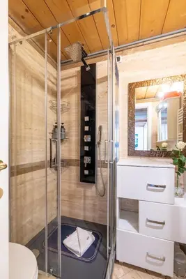 a shower with a glass door in a bathroom at Parioli Suite-duplex apartment in Rome