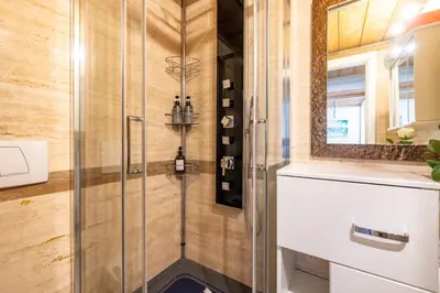 a shower with a glass door in a bathroom at Parioli Suite-duplex apartment in Rome