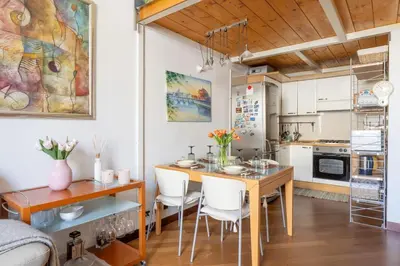a kitchen with a table and chairs and a dining room at Parioli Suite-duplex apartment in Rome