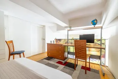 a bedroom with a bed and a desk and a television at Parioli Suite-duplex apartment in Rome