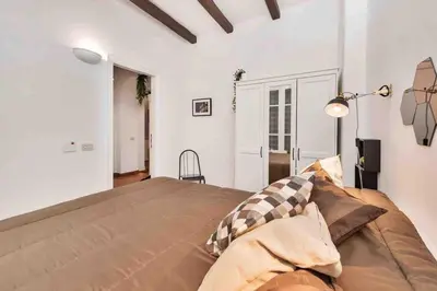 a bedroom with a large bed in a white room at Gianicolo Maison nel cuore di Roma in Rome